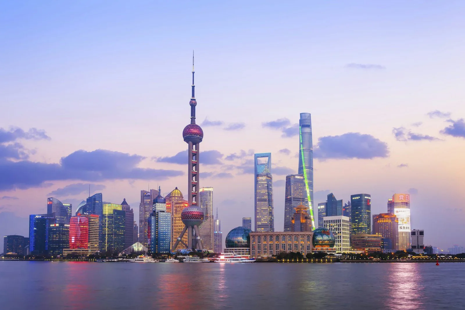 Shanghai's Pudong skyline at dusk across the Huangpu River